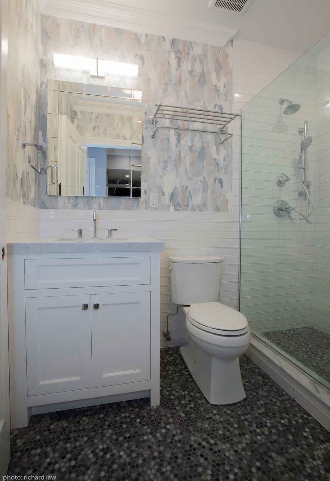 Larger view of bathroom with sink, toilet and shower
